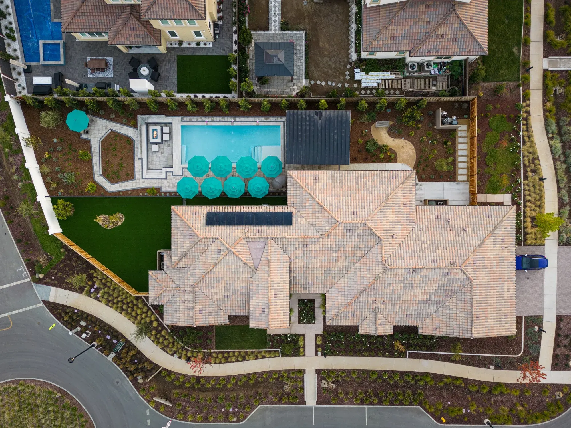 Aerial view of a finished pool yard with a paver terrace