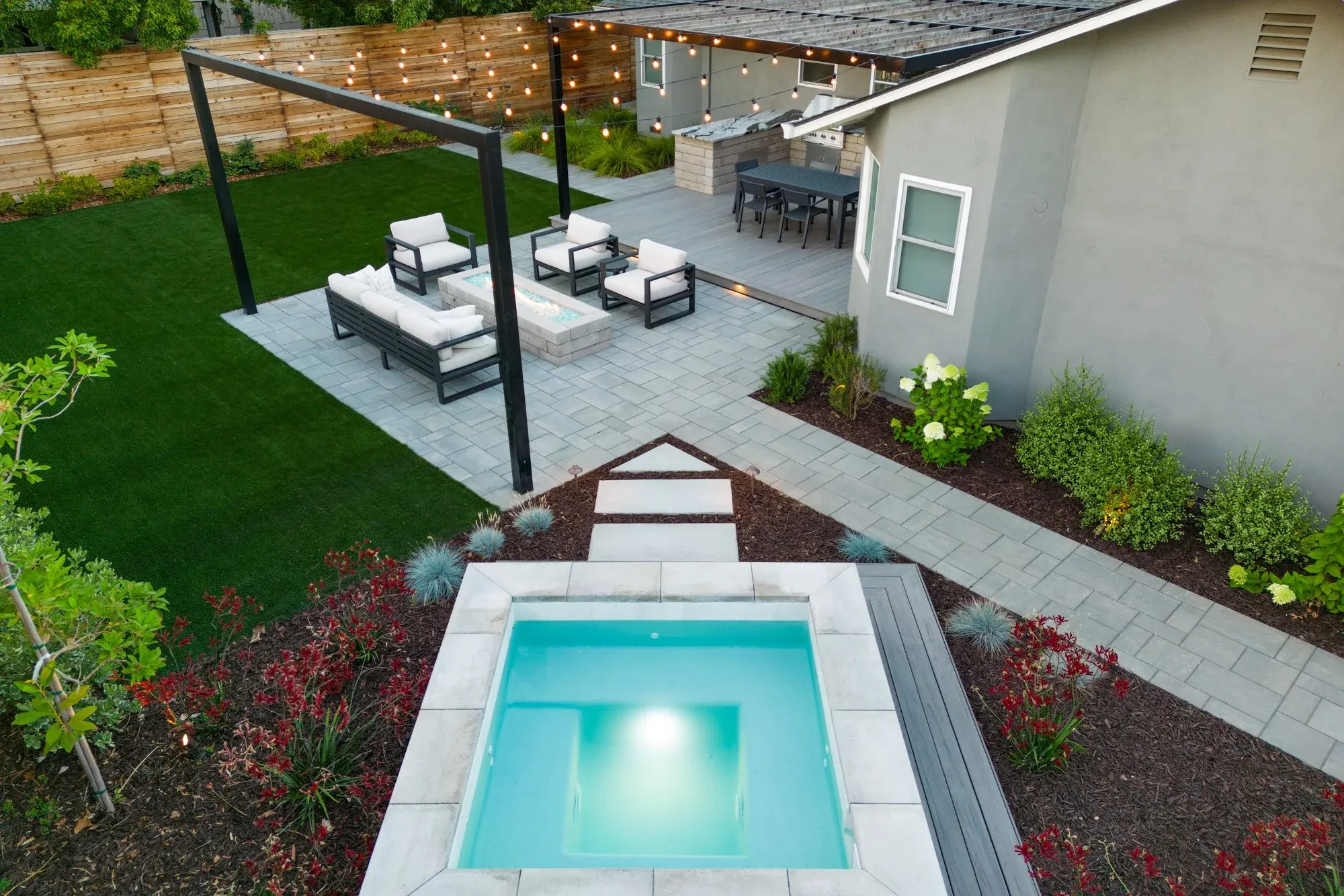 Aerial view of a plunge spa set into a paver terrace