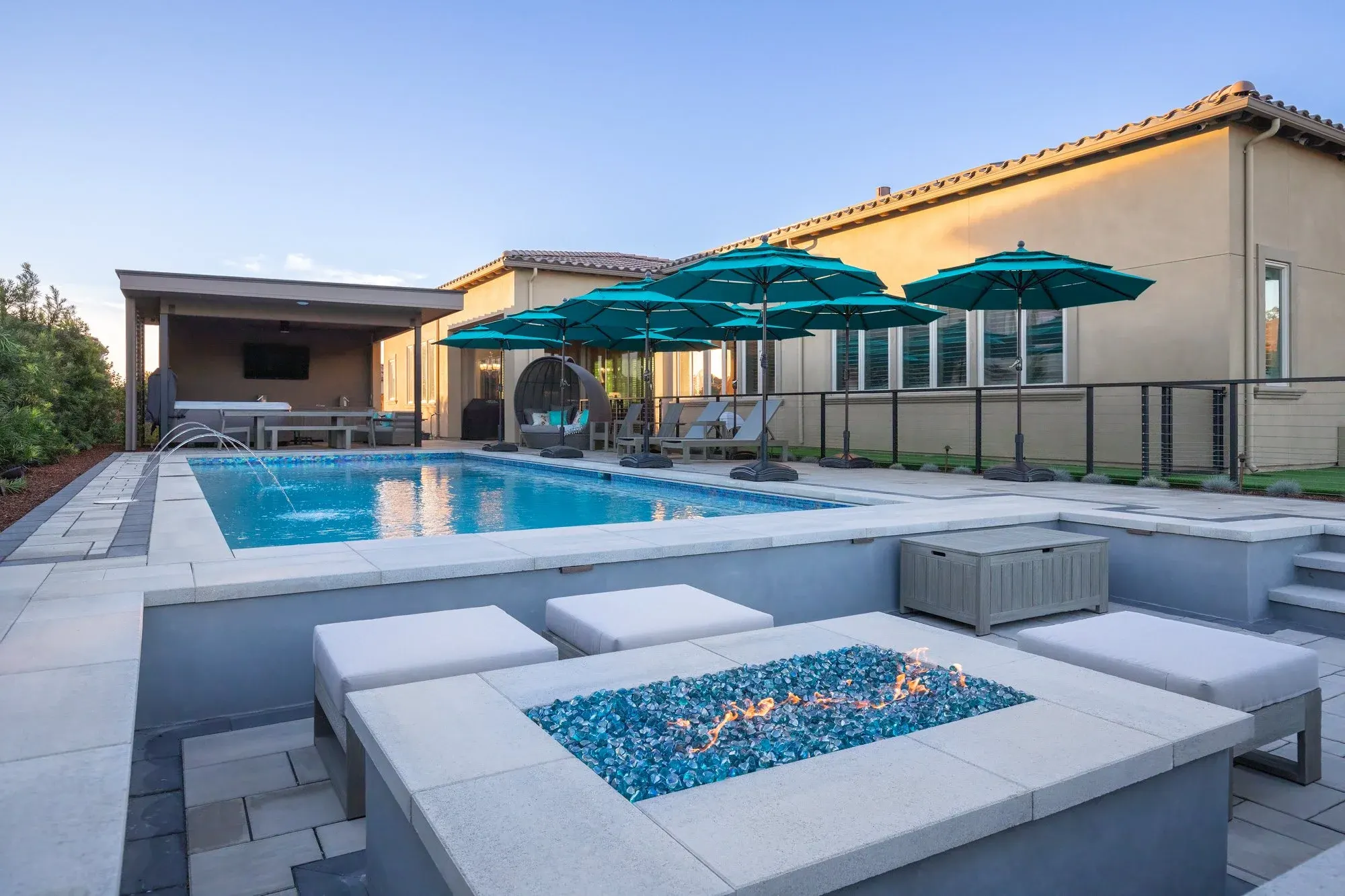 Fire table with blue glass at the pool edge