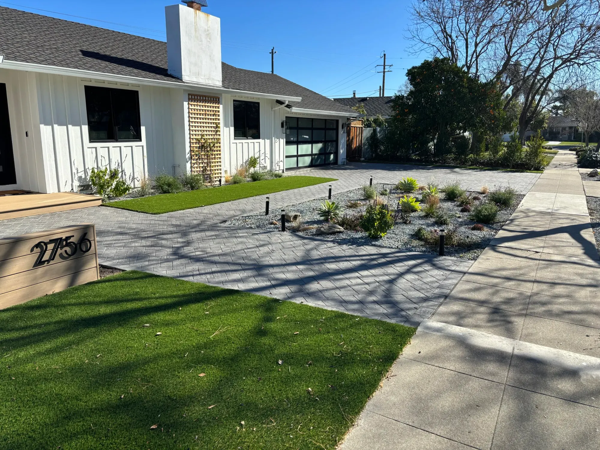 Paver drive with a planting bed along its edge