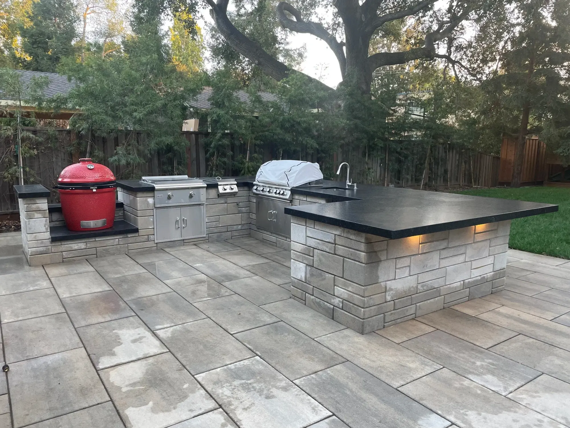Kamado grill set into an island on pavers