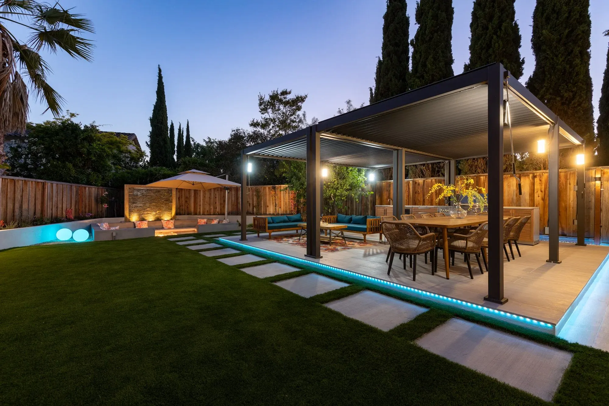 Lit pavilion and lawn at blue hour
