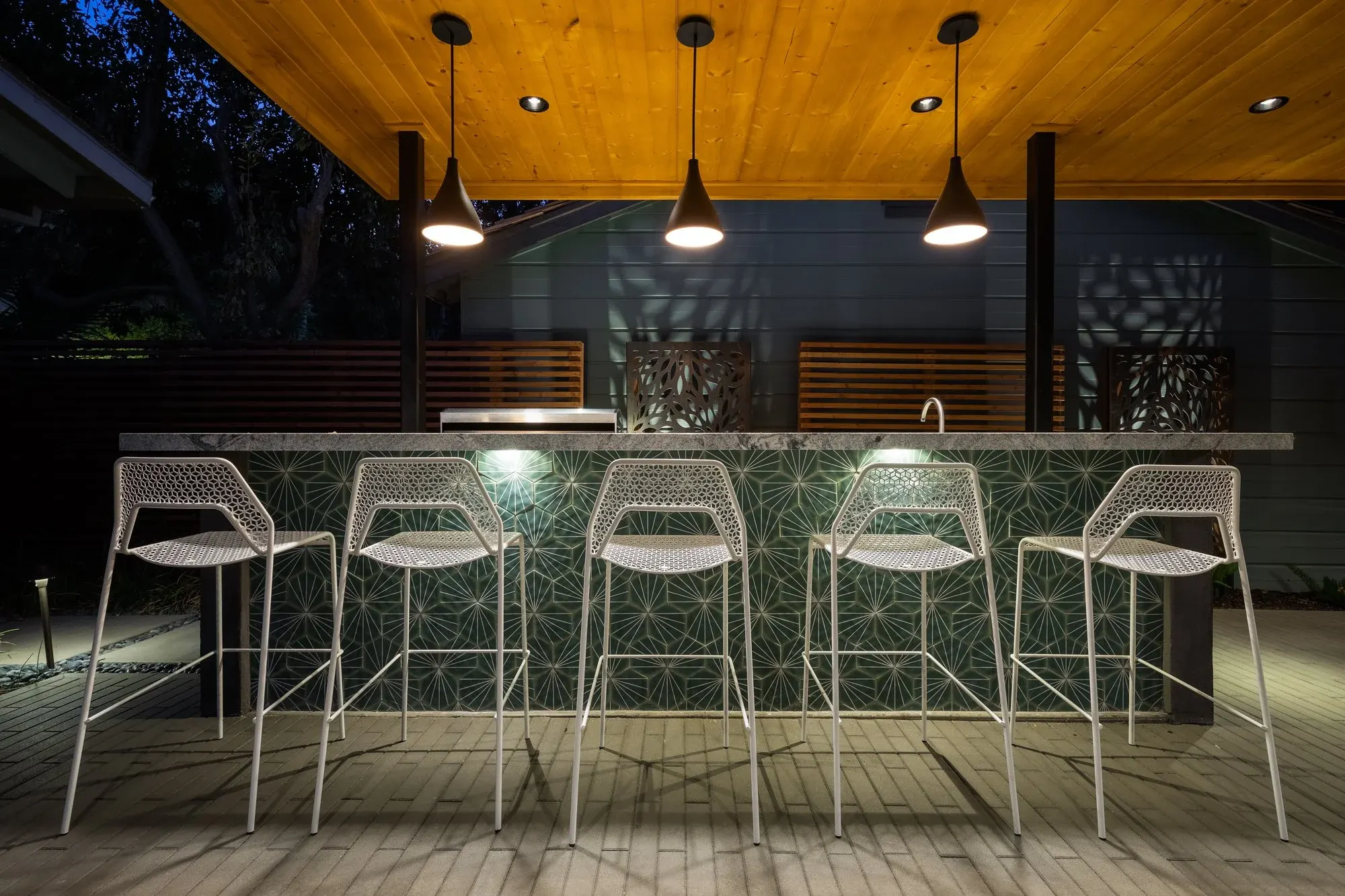 Lit stone bar under a wood ceiling