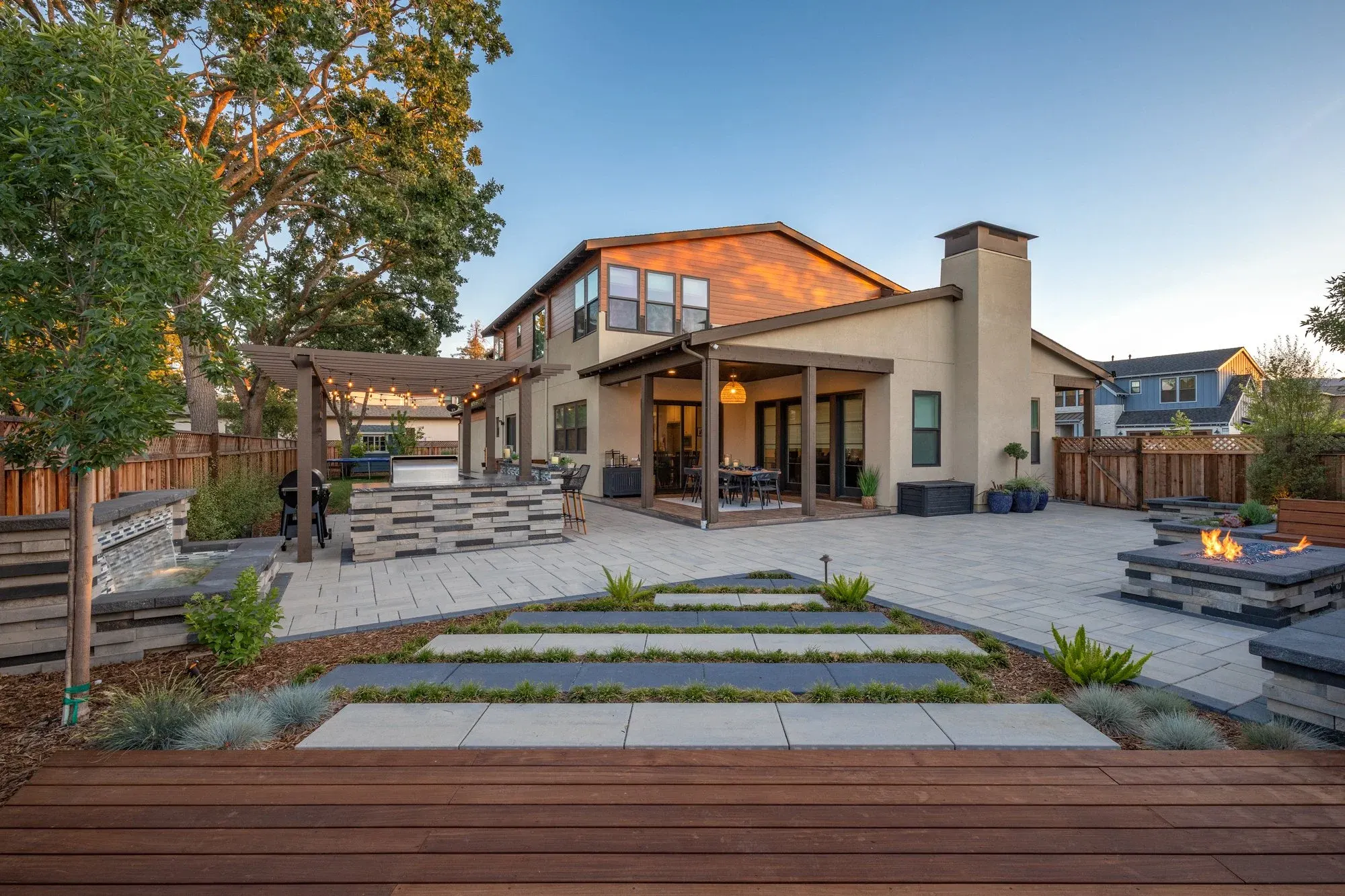 Paver courtyard in front of a two-story house