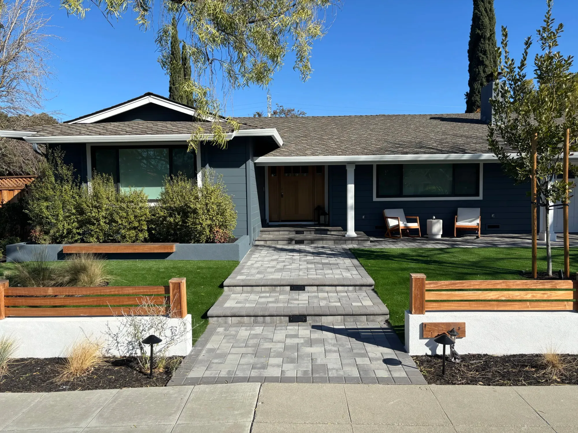 Paver front walk lined with built-in wood benches