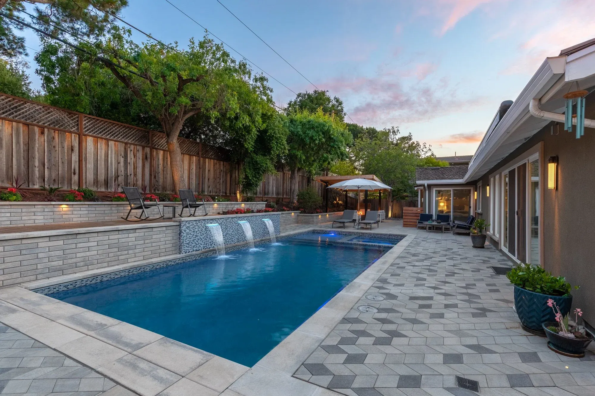 Paver pool deck with a water feature