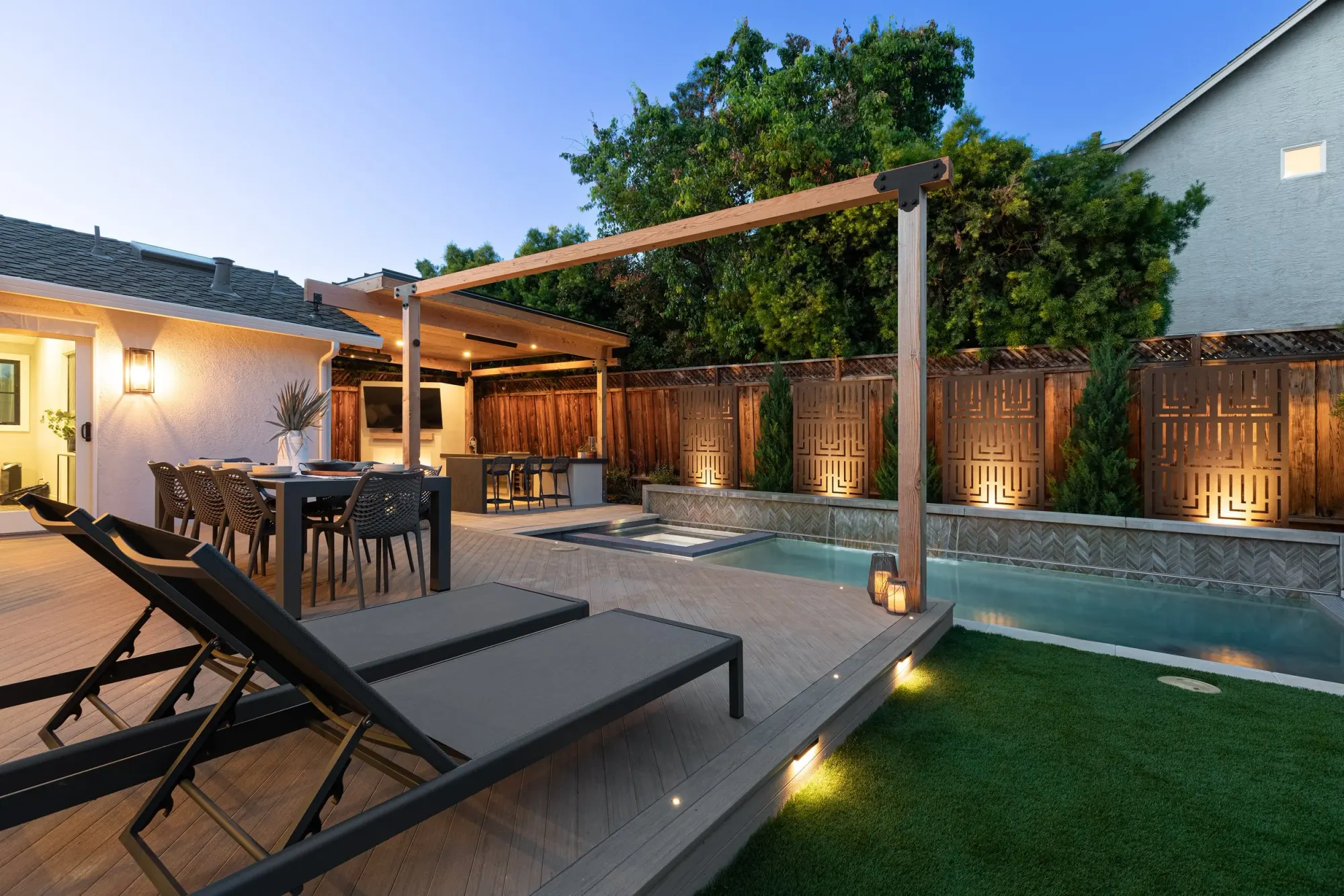 Pergola-covered dining terrace beside a pool