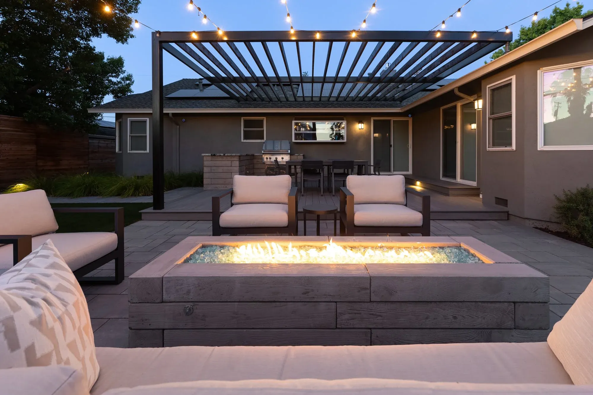 Lounge under a wood pergola at dusk