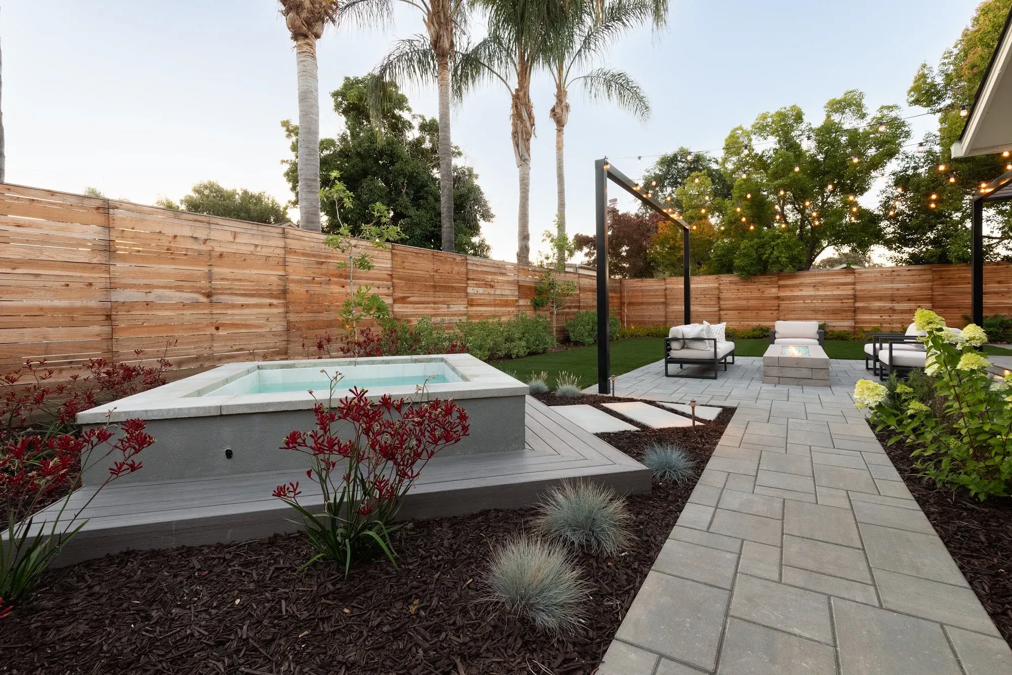 Raised spa beside a paver path