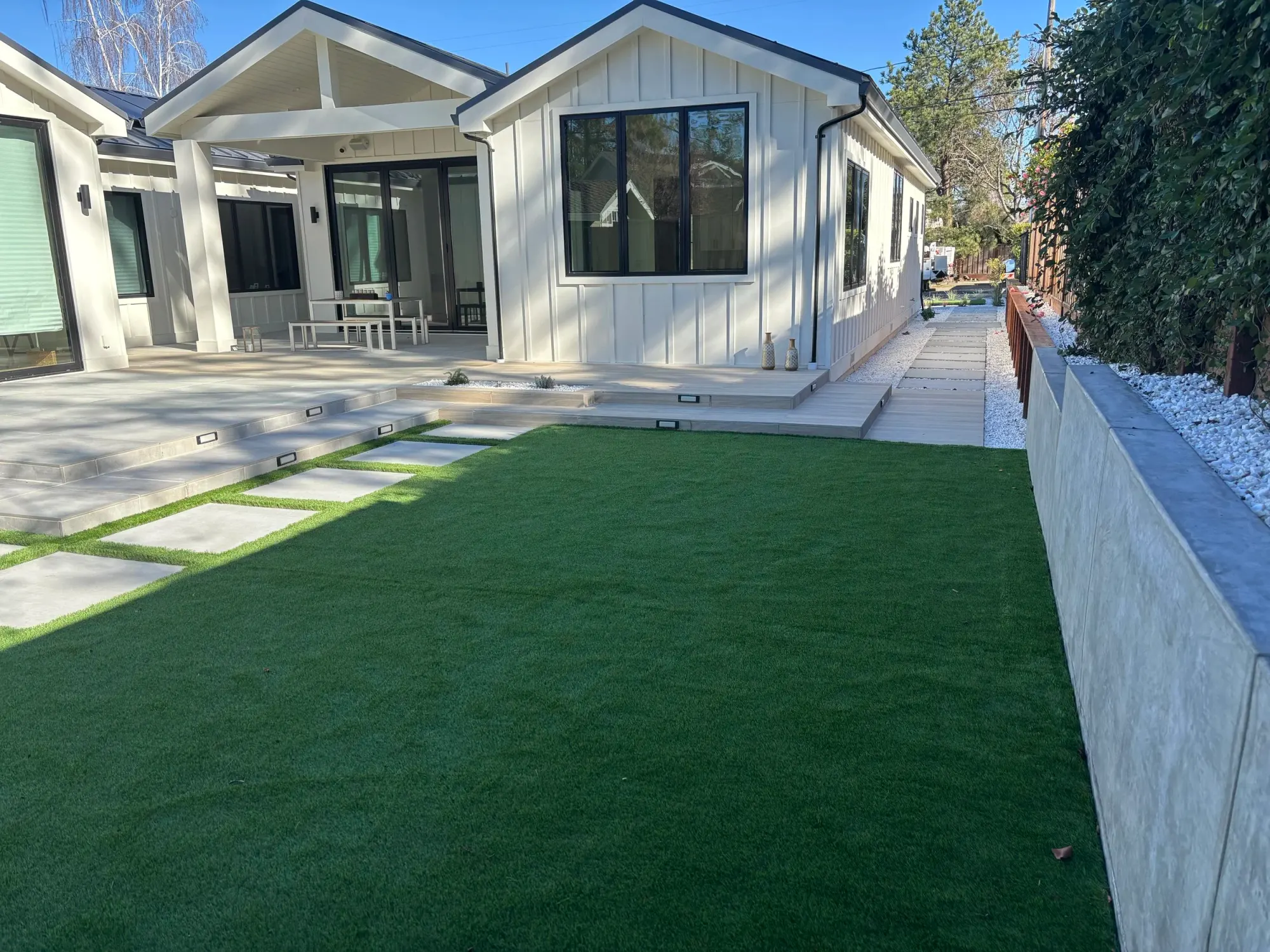 Side yard with turf and a concrete slab path