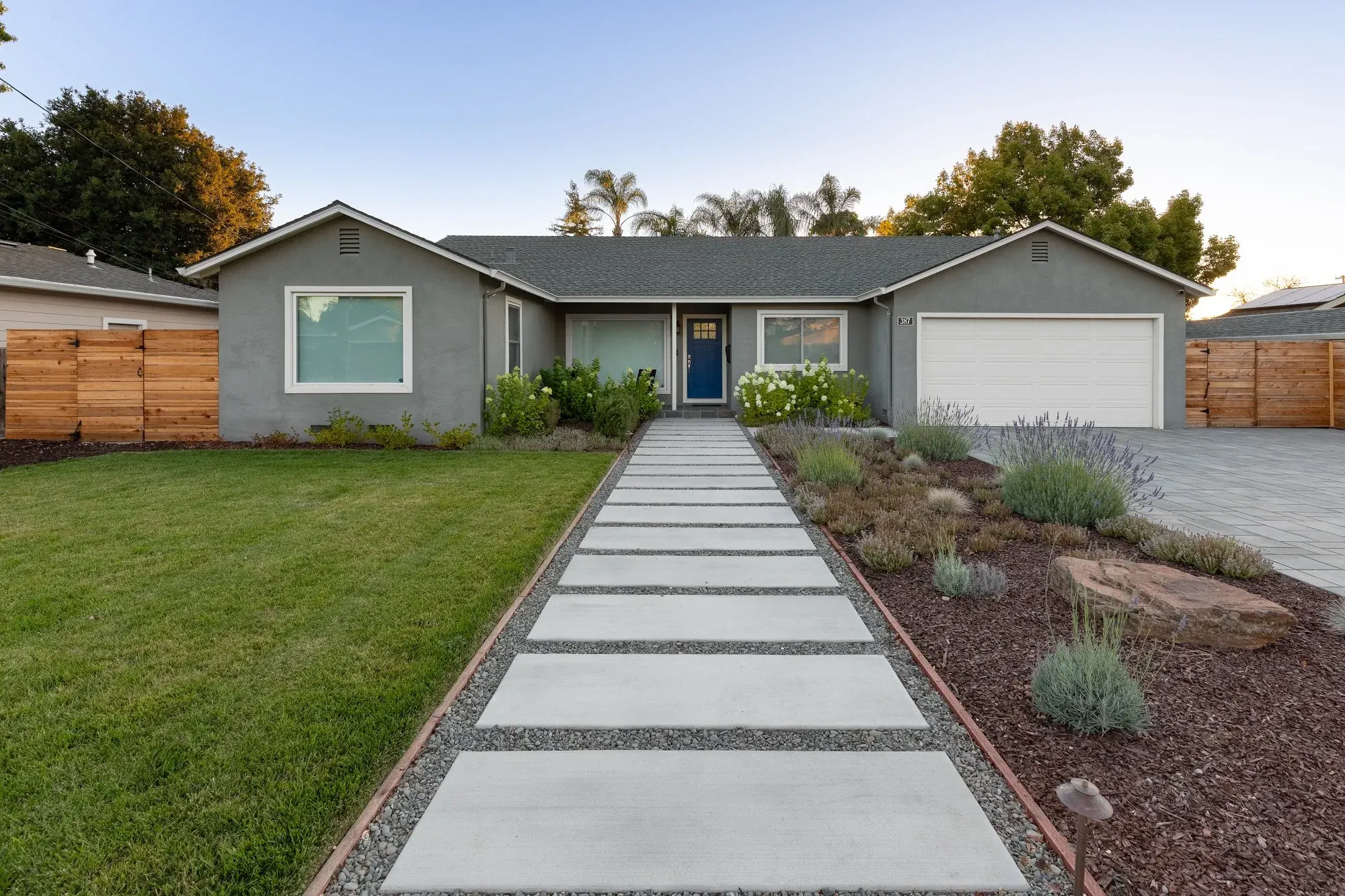 Concrete slab walk across a front lawn to the door