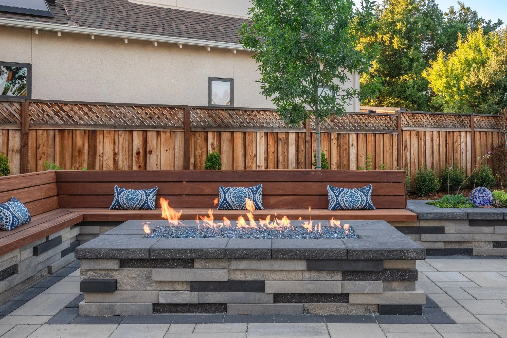 Stone fire table beside a built-in bench
