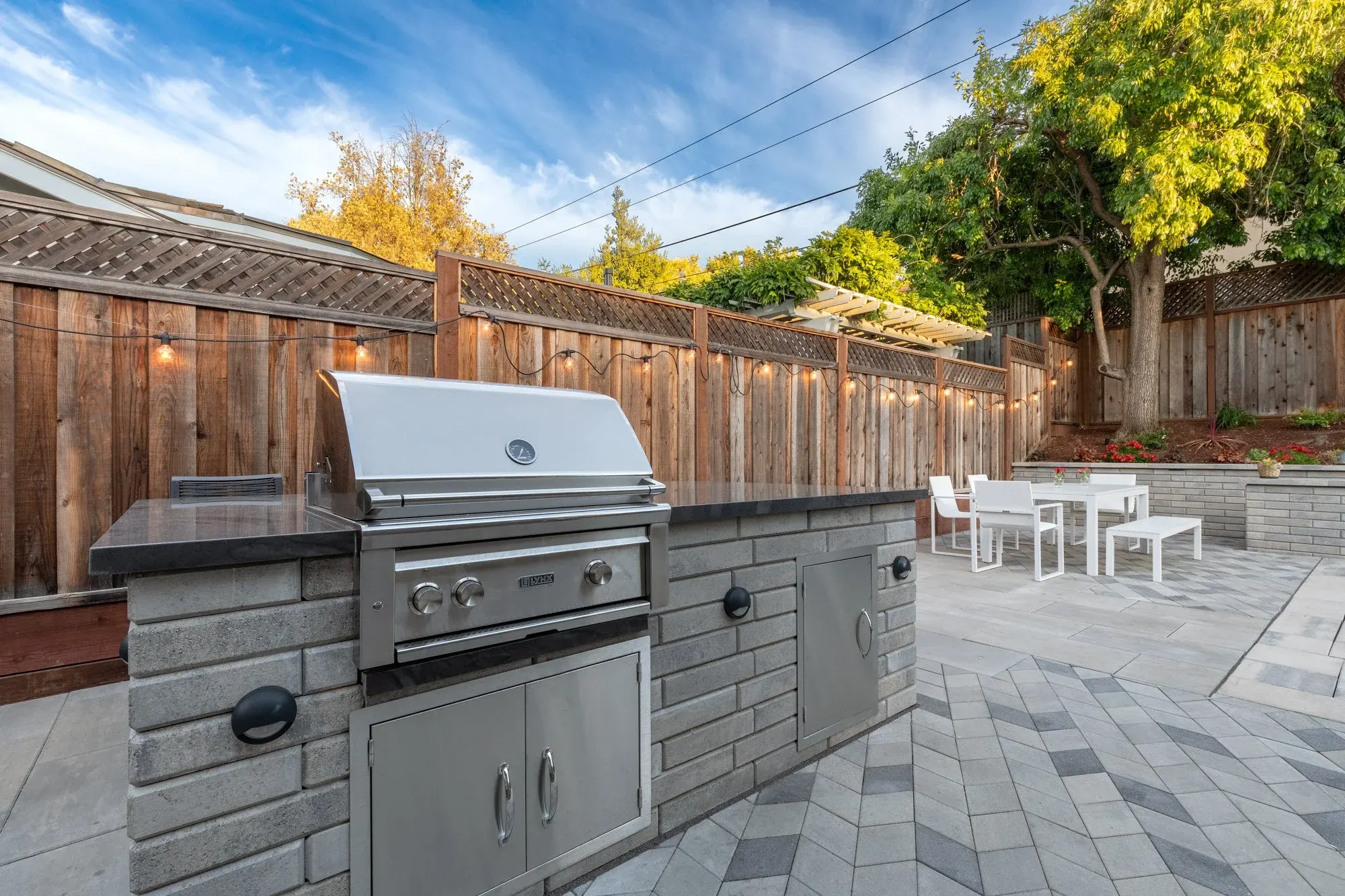 Stone veneer grill island on a paver patio