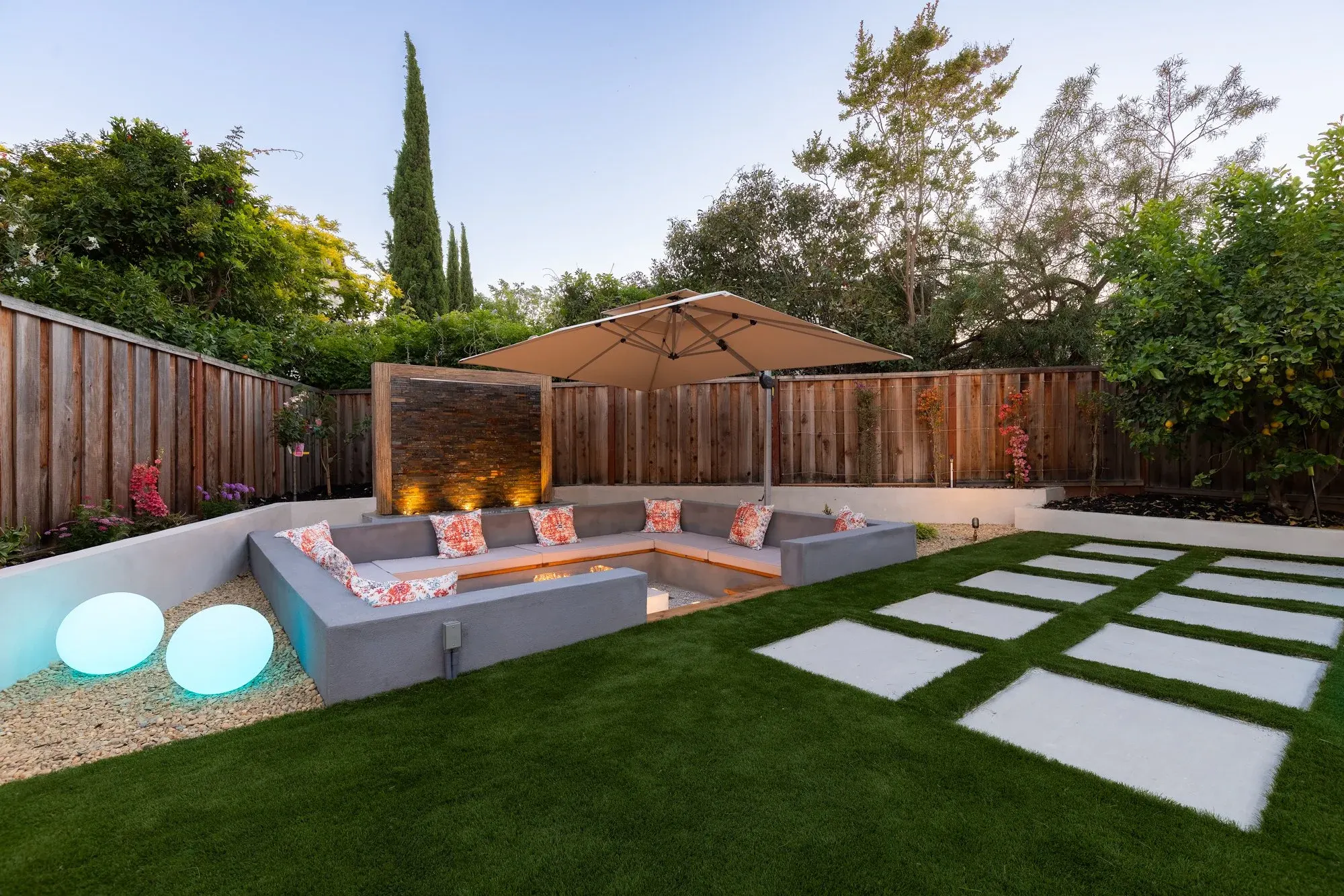 Sunken fire pit lounge beside a lawn