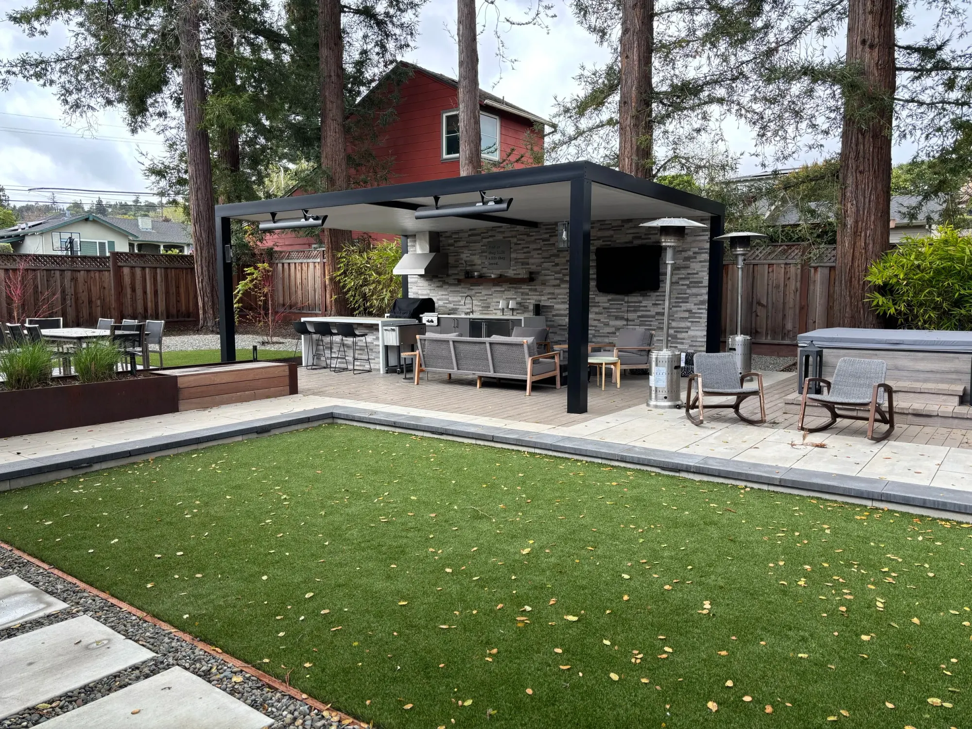 Turf lawn in front of a covered outdoor kitchen